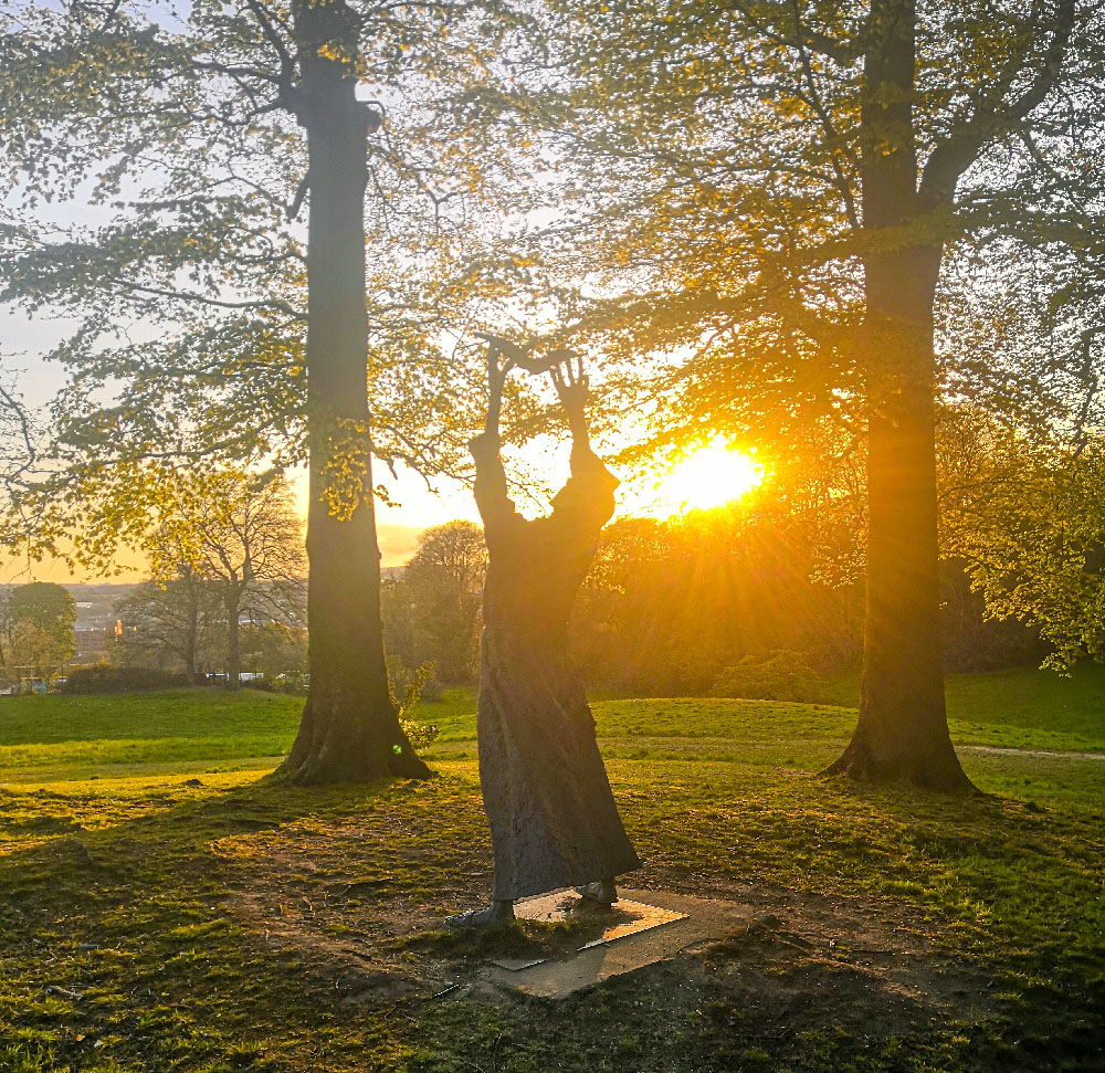 Image of the st columba statue in st  columb's park at sunset