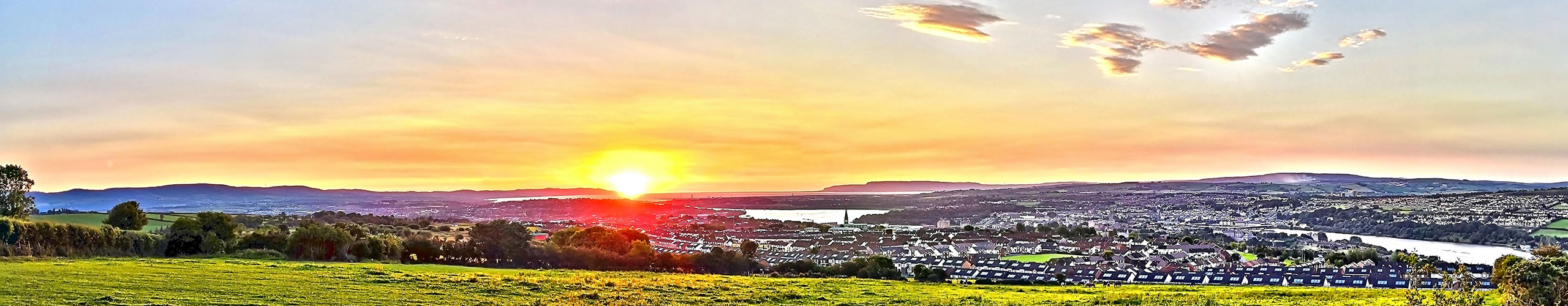 a photo of derry from creggan hill at sunrise